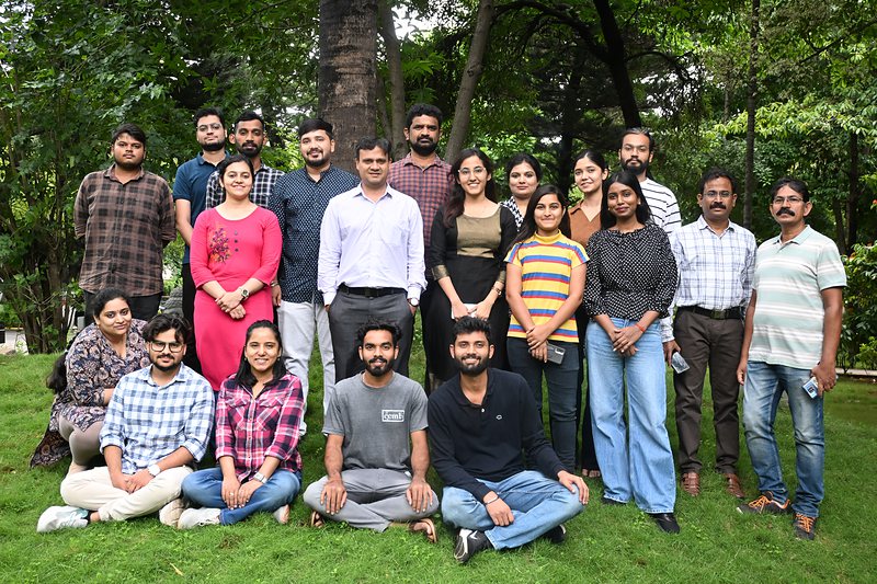 The lab team photographed together outdoors