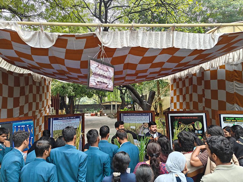 Visitors crowding the lab's outreach stall and poster display
