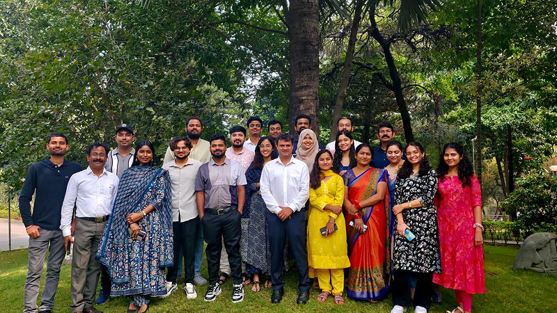 The lab team standing together under the trees