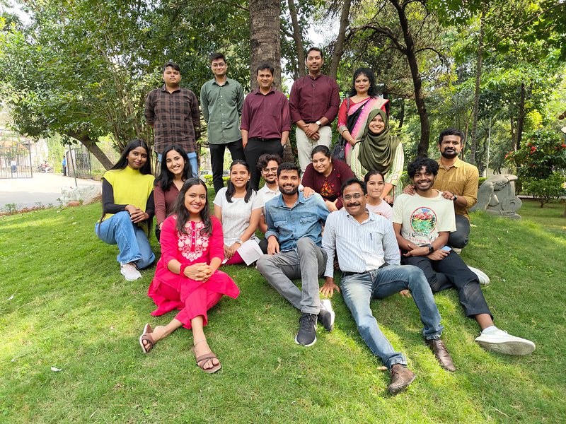 Lab members seated and standing on the lawn